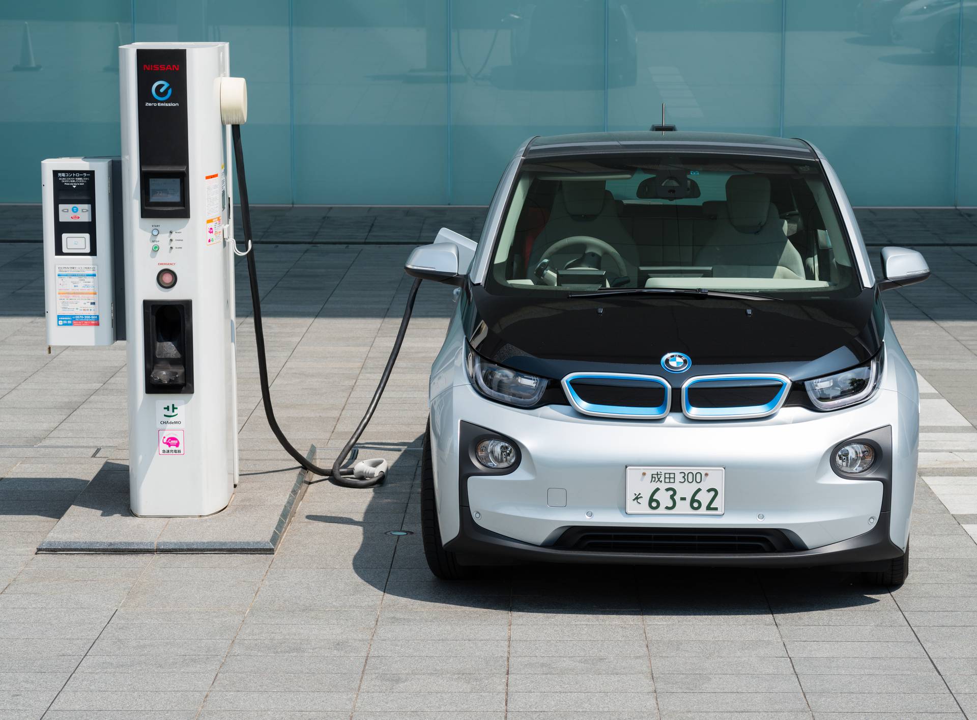 Electric car being charged at charging station