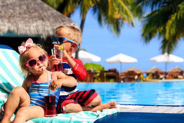 Kids,Relax,On,Tropical,Beach,Resort,And,Drink,Juices