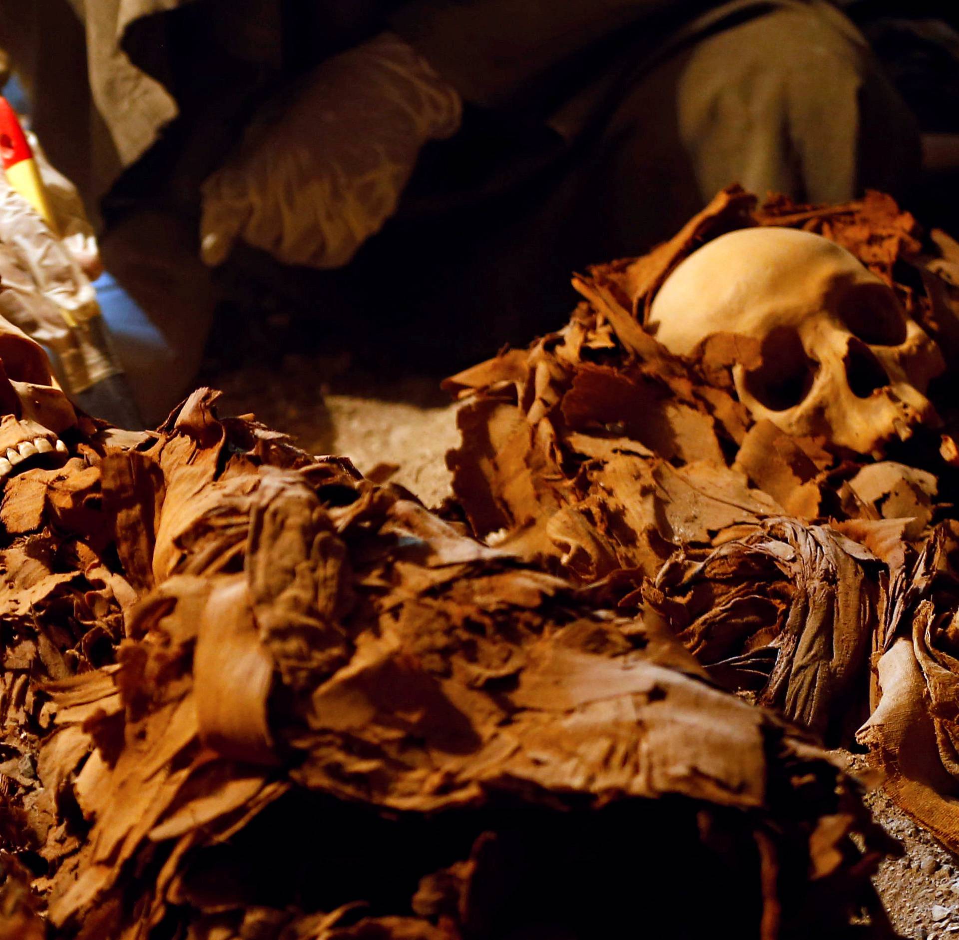 An Egyptian antiquities worker works in the recently discovered tomb of Amenemhat, a goldsmith from the New Kingdom, at the Draa Abu-el Naga necropolis near the Nile city of Luxor