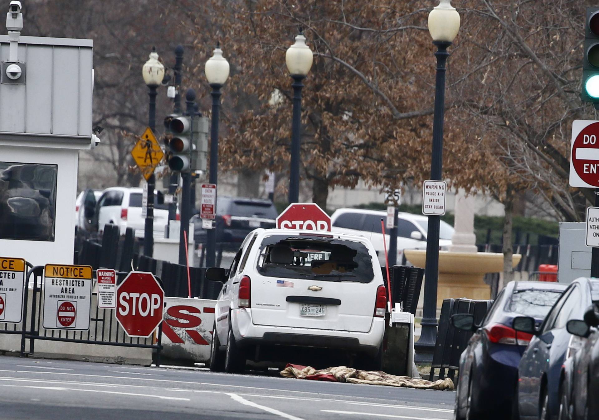 A passenger vehicle that struck a security barrier sits near the White House in Washington