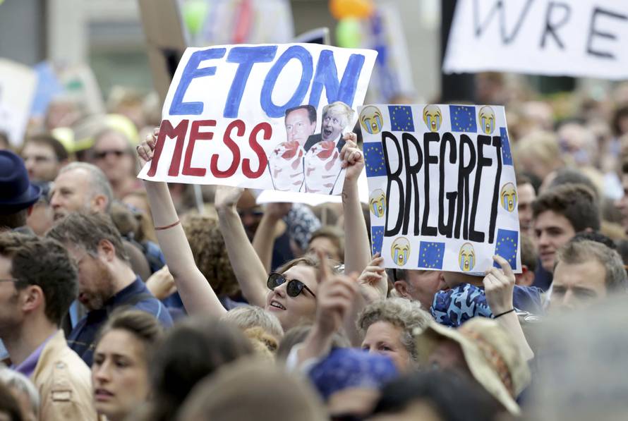 People hold banners during a demonstration against Britain's decision to leave the European Union, in central London