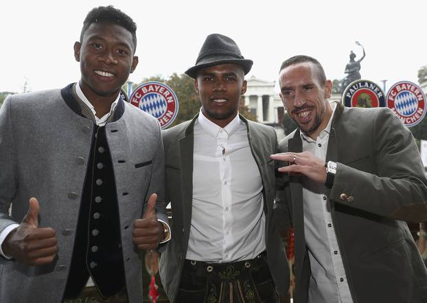  Alaba, Costa, and Ribery of FC Bayern Munich pose during their visit at the Oktoberfest in Munich