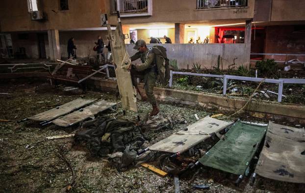 An Israeli soldier prepares stretchers at the impact site after Iranian missile barrages struck residential buildings in Arad, amid the U.S.-Israel conflict with Iran, in southern Israe