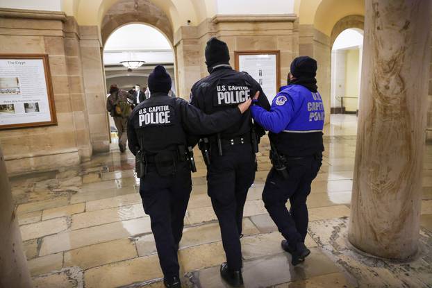 Members of the U.S. Capitol Police walk inside the Capitol as supporters of U.S. President Donald Trump protest outside, in Washington