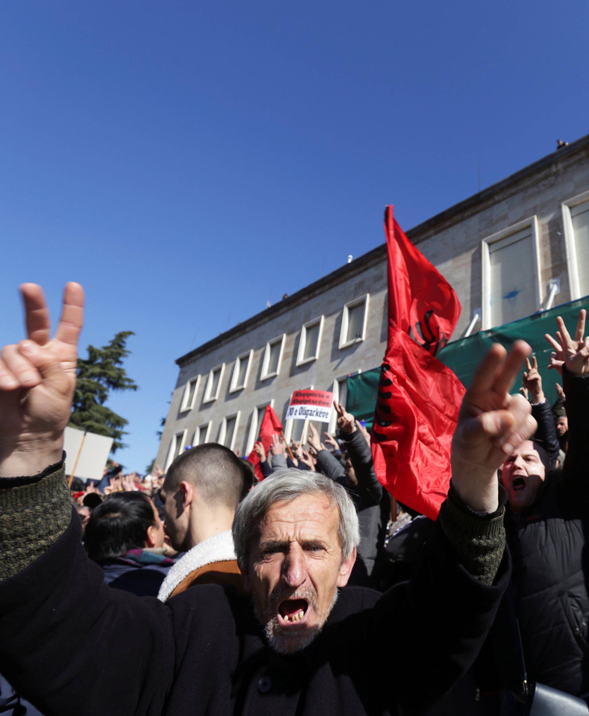 Supporters of the opposition party wave Albanian flags during an anti-government protest in front of the office of Albanian Prime Minister Edi Rama in Tirana