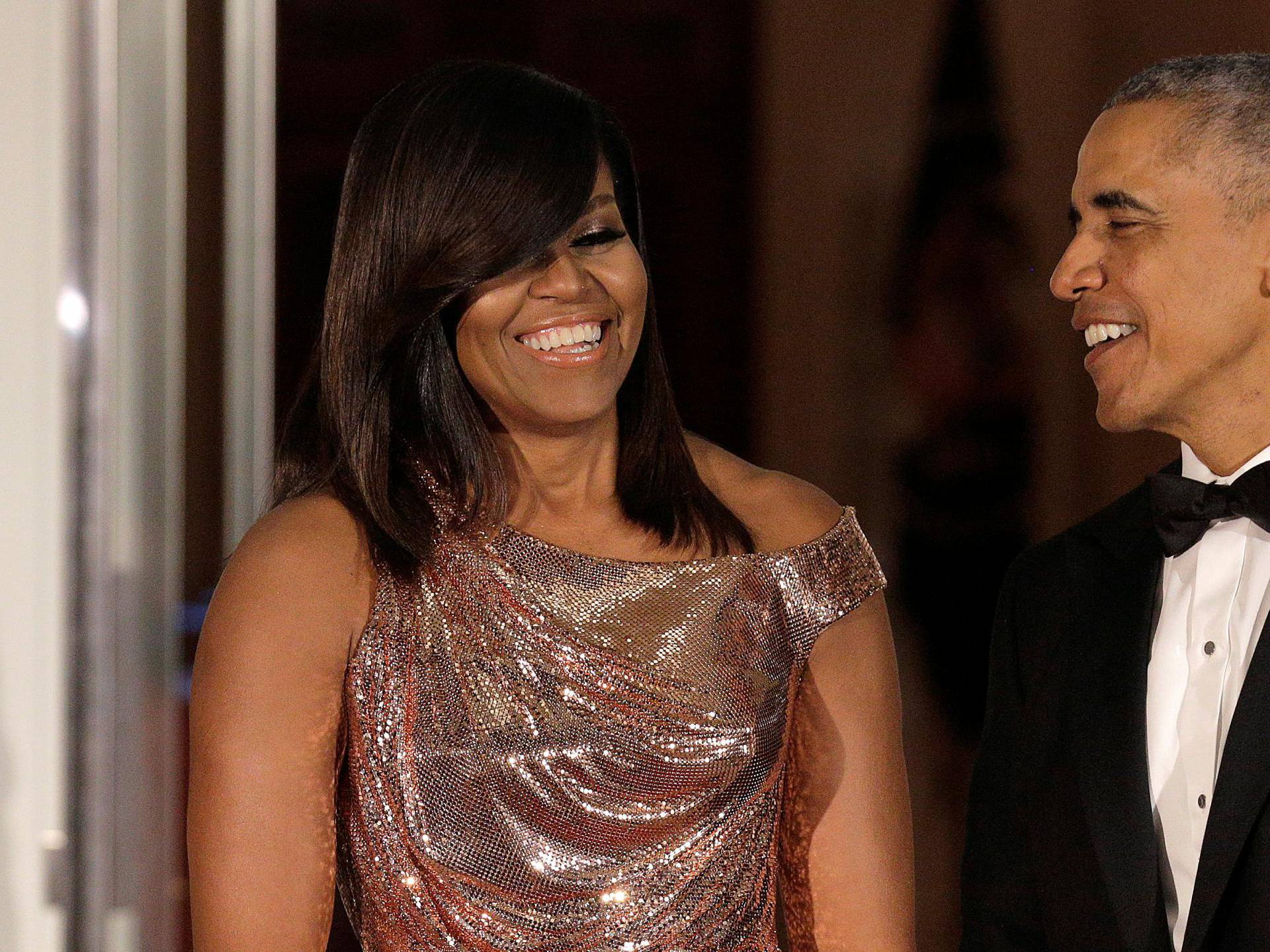 U.S. President Barack Obama and U.S. first lady Michelle Obama speak before the arrival of Italian Prime Minister Matteo Renzi and his wife Agnese Landini at the White House in Washington.