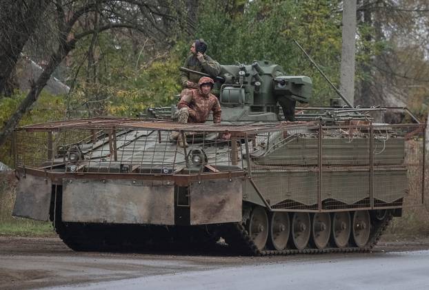 Ukrainian servicemen ride a Marder infantry fighting vehicle in the Donetsk region