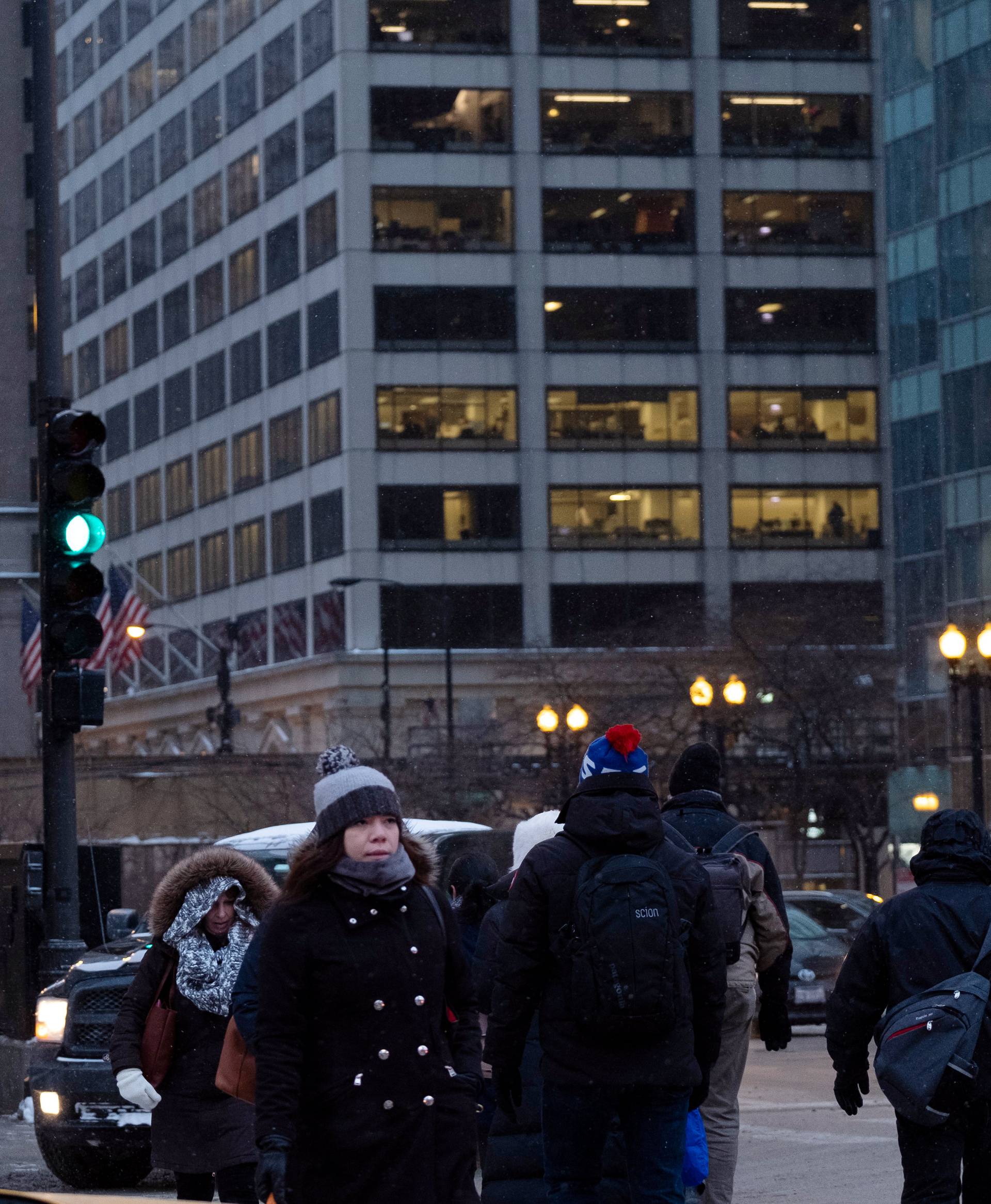 Pedestrians cross the street at rush hour as bitter cold phenomenon called the polar vortex has descended on much of the central and eastern United States