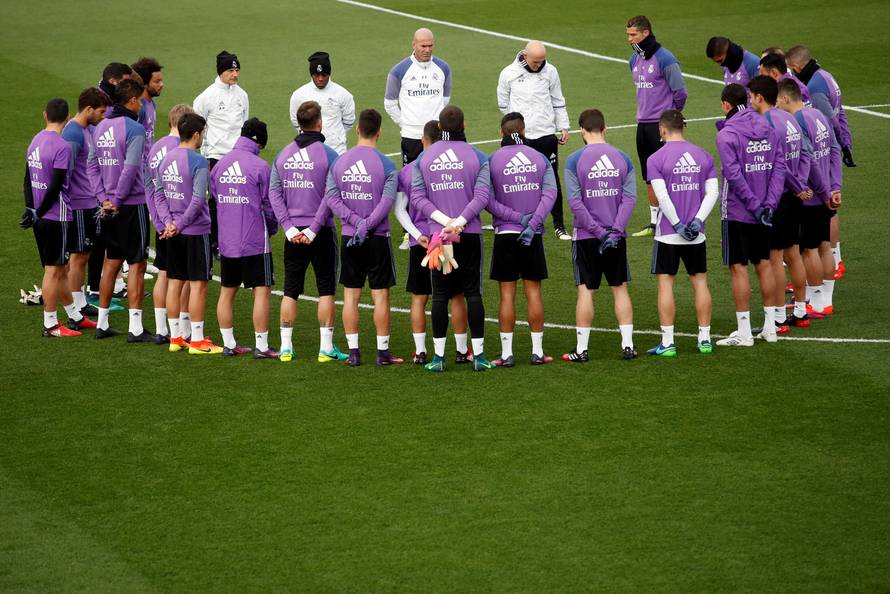 Real Madrid's players observe a minute of silence at Real Madrid's Valdebebas training ground outside Madrid