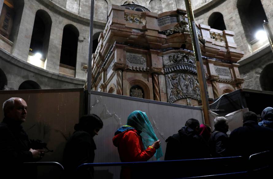 Visitors stand near the newly restored Edicule, the ancient structure housing the tomb, which according to Christian belief is where Jesus's body was anointed and buried, at the Church of the Holy Sepulchre in Jerusalem's Old City