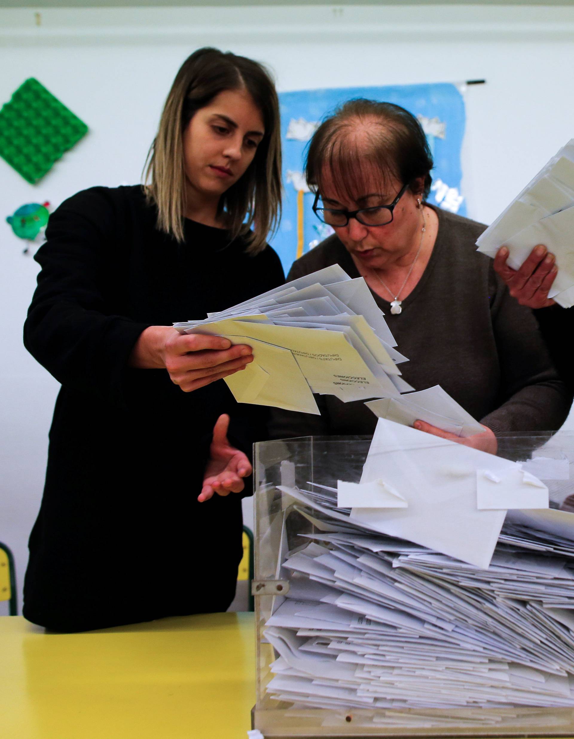 Electoral workers begin to count ballots after polls closed in Catalonia's regional elections at a polling station in Barcelona