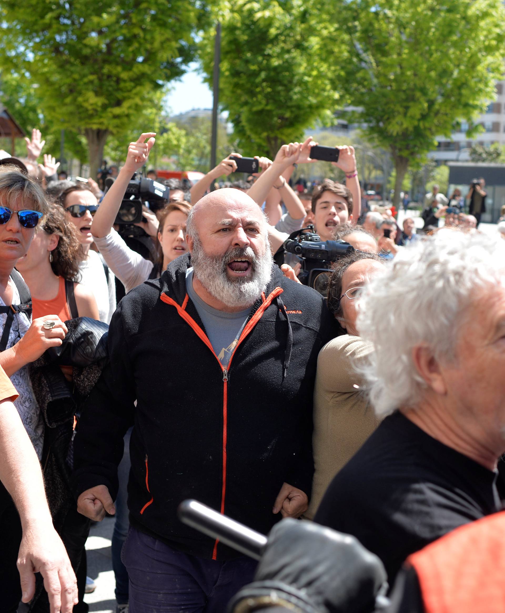 Protesters break through a police line after a nine-year sentence was given to five men accused of the multiple rape of a woman during Pamplona's San Fermin festival in 2016