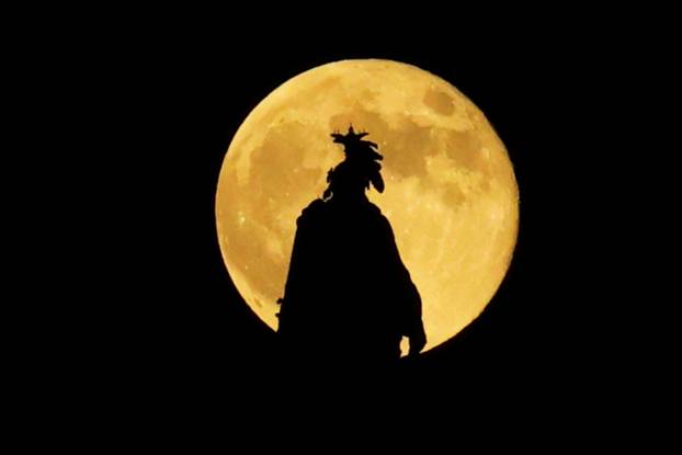 Full moon, known as the Hunter's moon, rises over the Statue of Freedom, in Washington