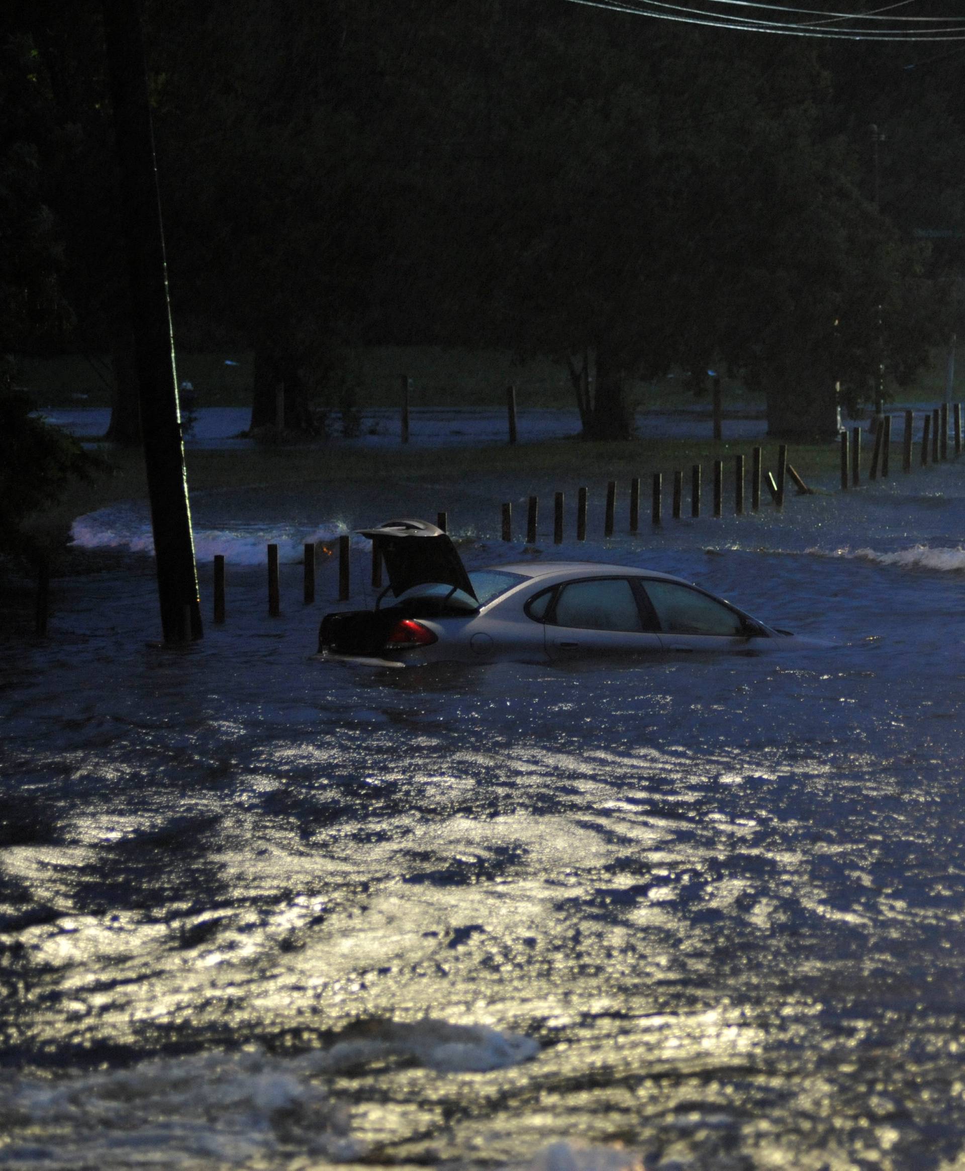 An abandoned vehicle is covered by floodwater after Hurricane Harvey inundated the Texas Gulf coast with rain causing widespread flooding, in Houston