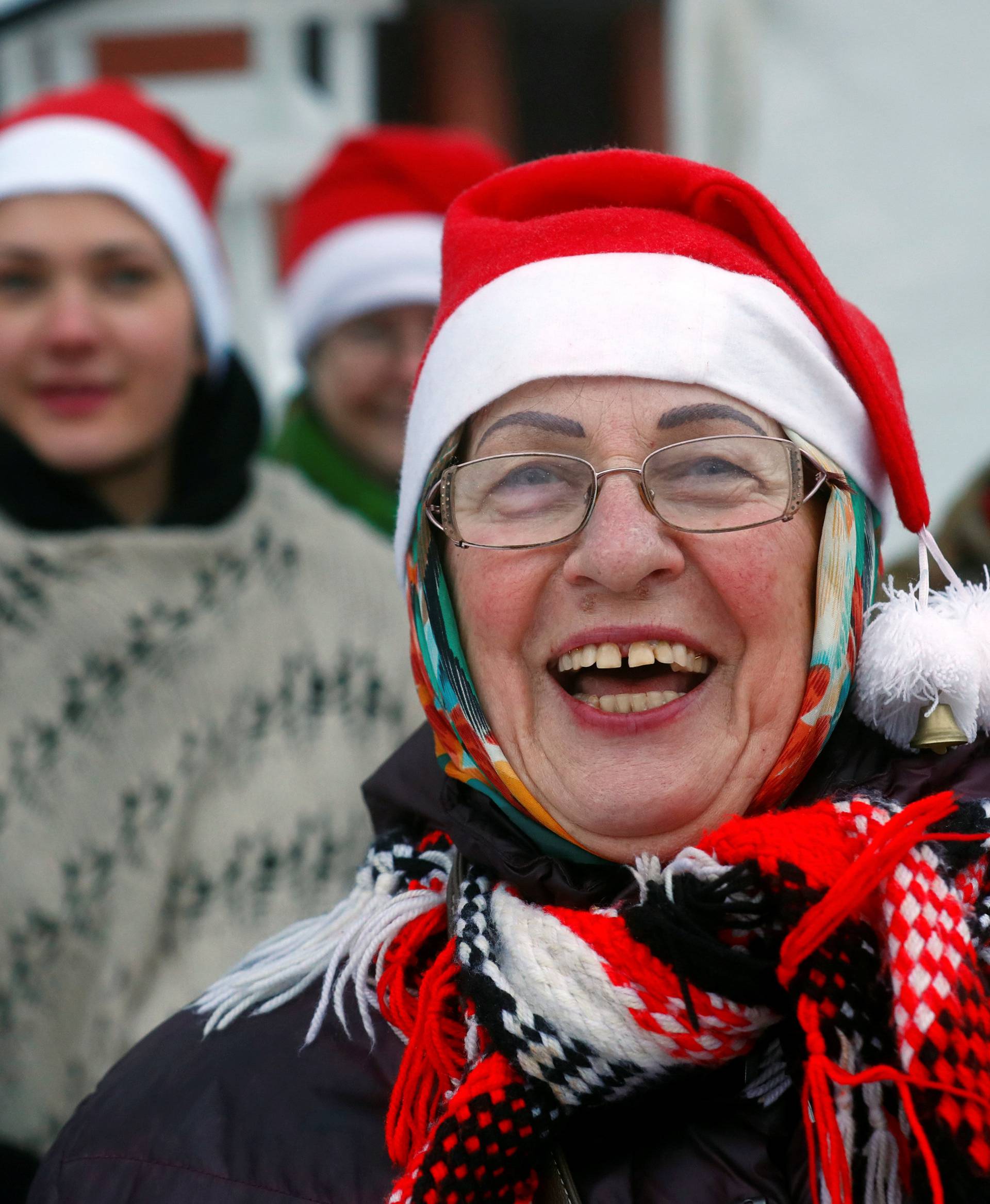 A woman wears Santa Claus hat as she attends the event to mark the 10th anniversary since Latvia and Estonia joined the Schengen area in bordertown Valka