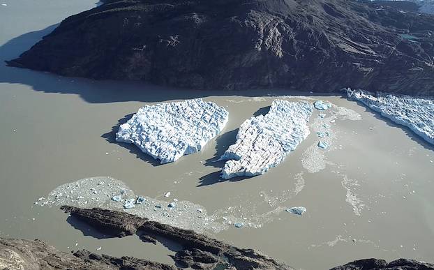 Two new icebergs are seen after breaking off from the Grey glacier in Patagonia