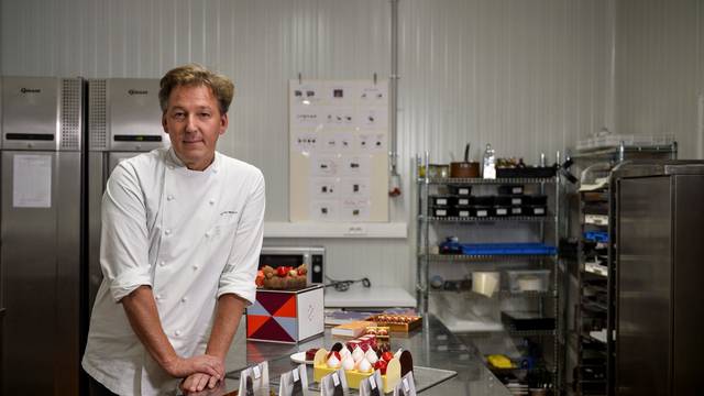 Belgian chocolatier Pierre Marcolini poses in his kitchen workshop after being crowned best pastry chef in the world by his peers at international competition, in Brussels