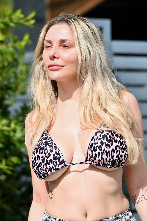 EXCLUSIVE: Courtney Stodden is seen for the first time after surgery as she steps out wearing a bikini top as she takes the trash out in Los Angeles