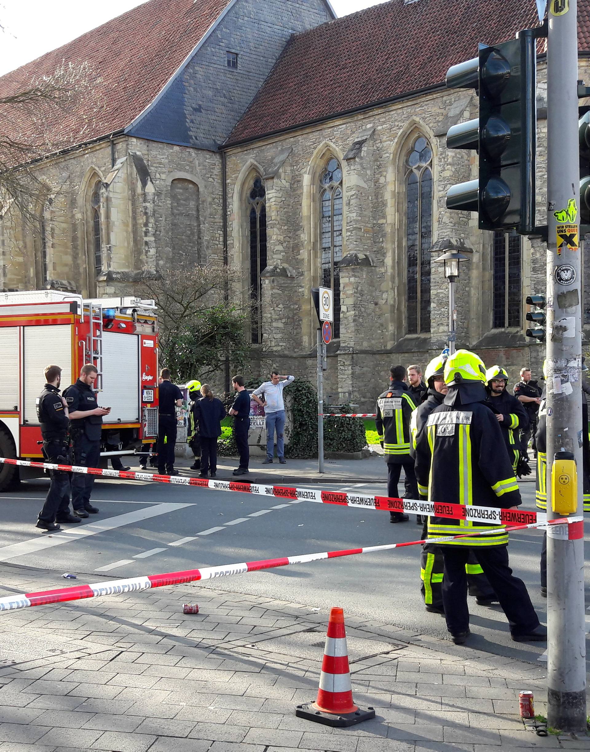 Police block a street near a place where a man drove a van into a group of people sitting outside a popular restaurant in the old city centre of Muenster