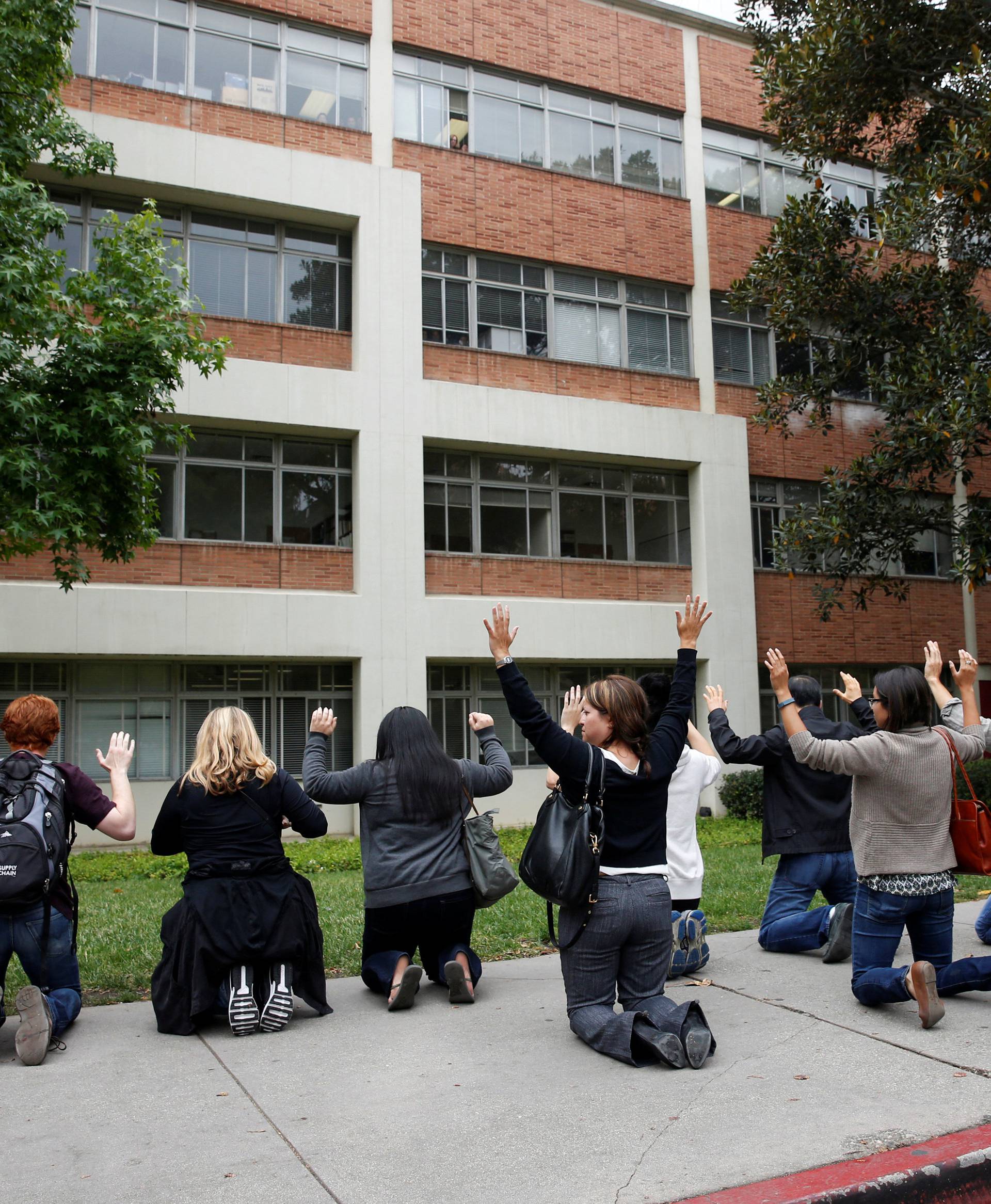 A police officer conducts a search on people at the UCLA campus after it was placed on lockdown following reports of a shooter that left 2 people dead in Los Angeles, California