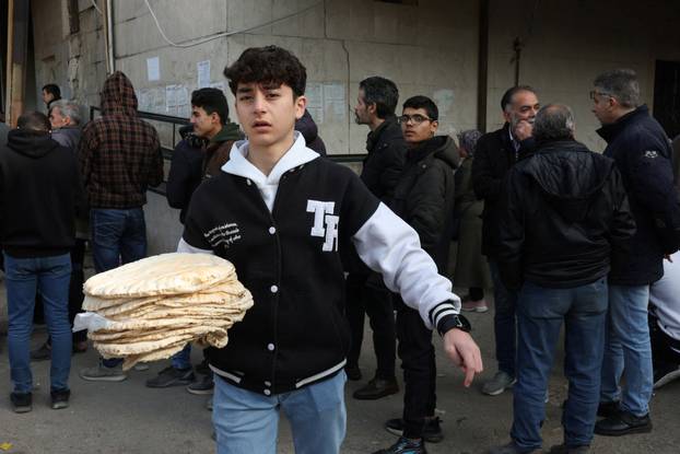 People queue to buy bread in Damascus