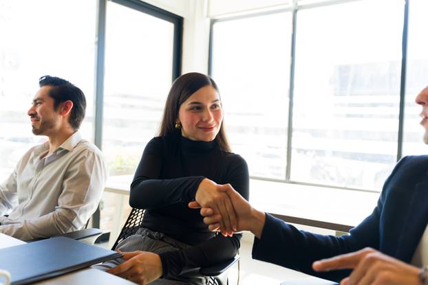 Businesswoman meeting another businssperson at an office