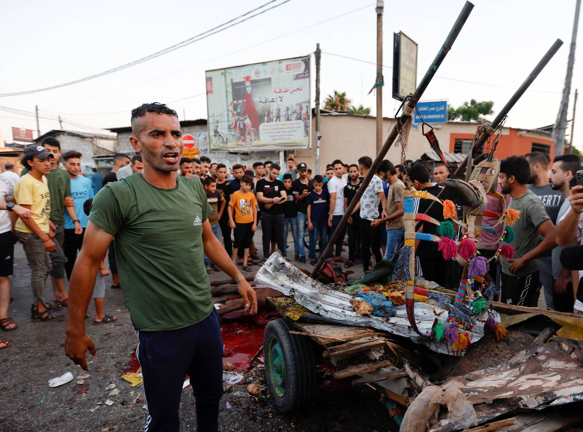 Palestinians inspect the damage, amid Israel-Gaza fighting