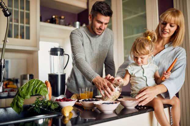 Happy,Family,With,Girl,In,Kitchen,Making,Breakfast,Together