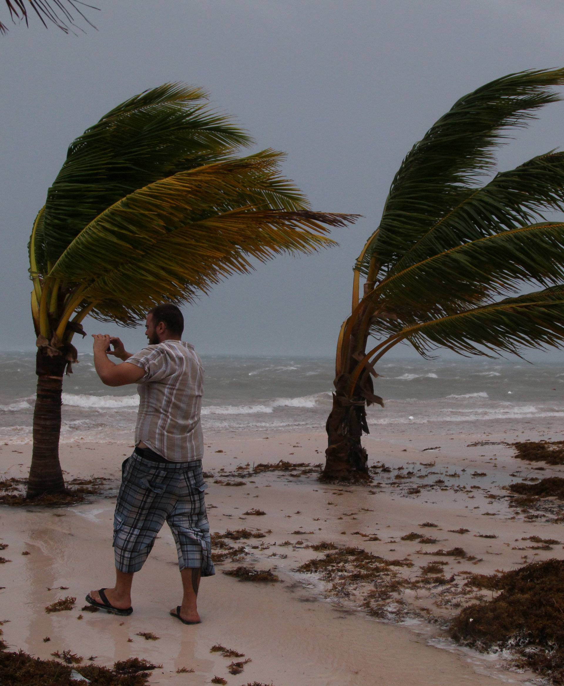 A man photographs the waves before the arrival of Hurricane Maria in Punta Cana