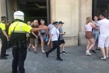 People are evacuated after a van crashed into pedestrians near the Las Ramblas avenue in central Barcelona