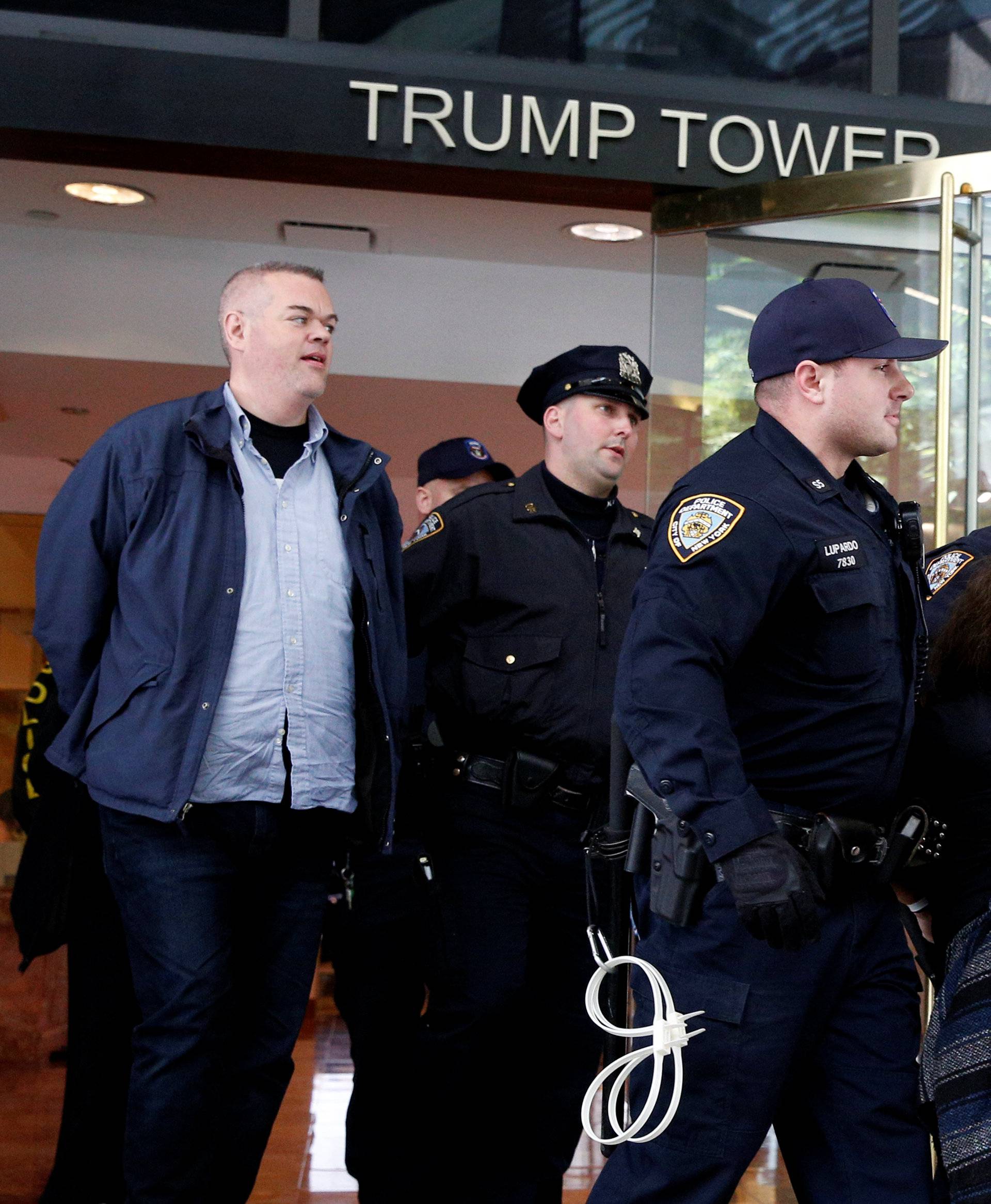 New York City Police officers (NYPD) carry and escorts protestors after making arrests for demonstrating in Trump Tower in New York City
