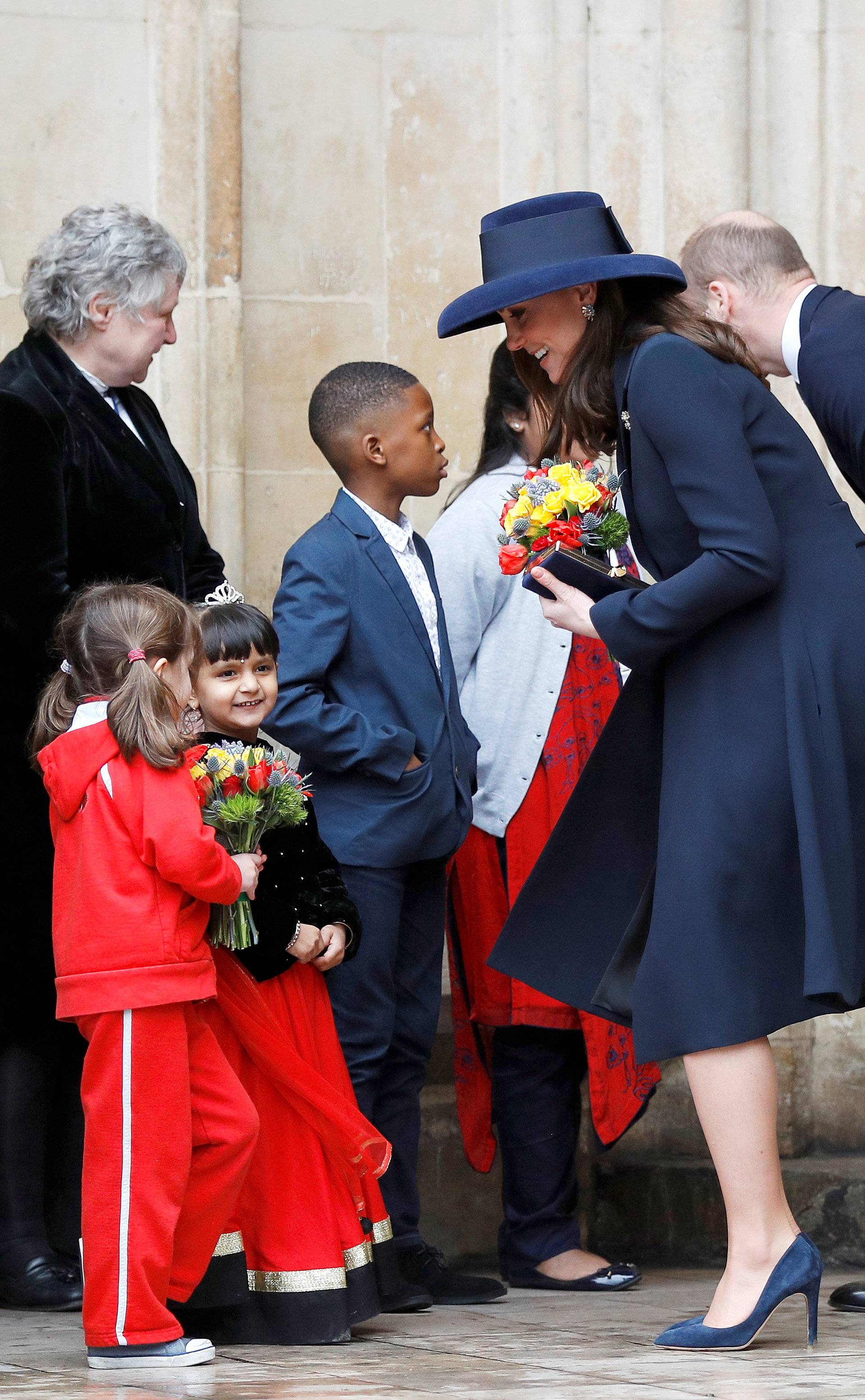 Britain's Prince William and Catherine, the Duchess of Cambridge, greet children after attending the Commonwealth Service at Westminster Abbey in London