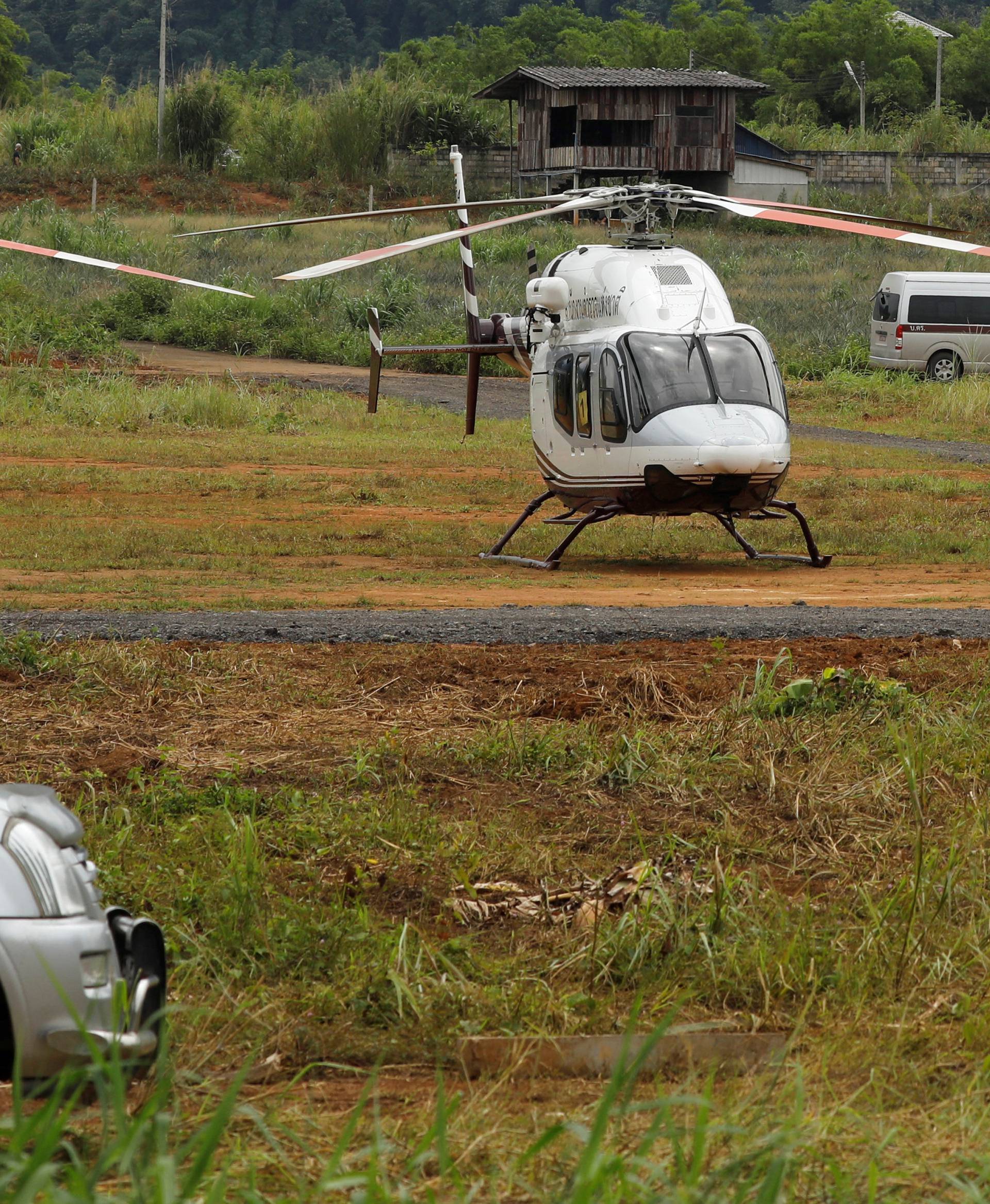 A general view shows helicopters expected to transport the schoolboys and their soccer coach who are trapped inside a flooded cave, in the northern province of Chiang Rai