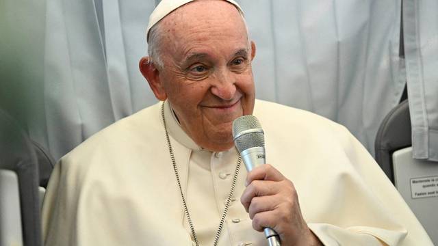 Pope Francis holds a news conference aboard the plane as he returns to the Vatican following his apostolic journey to Hungary