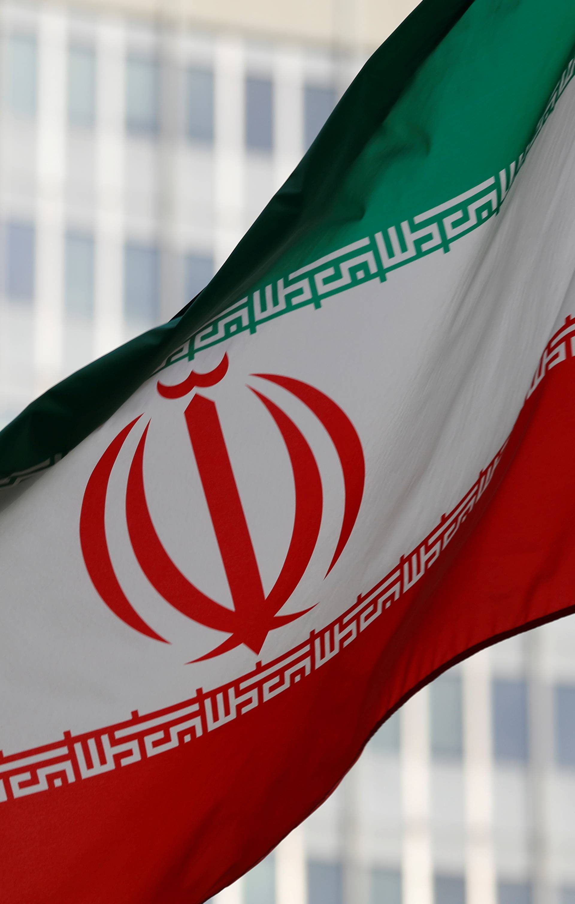 FILE PHOTO: The Iranian flag flutters in front the International Atomic Energy Agency (IAEA) headquarters in Vienna