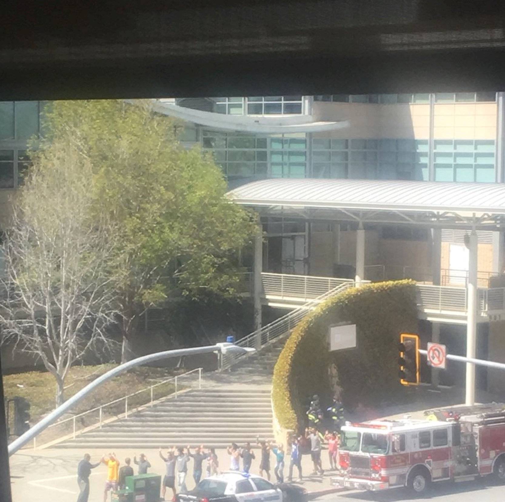 People gather outside a building following a shooting at the headquarters of YouTube, in San Bruno, California