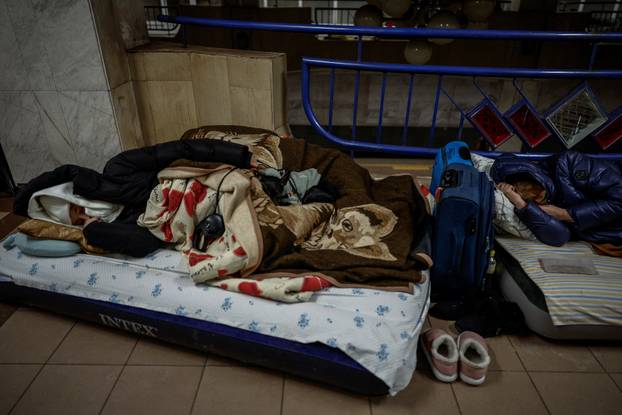 People take shelter inside a metro station during a Russian missile and drone attack, in Kyiv