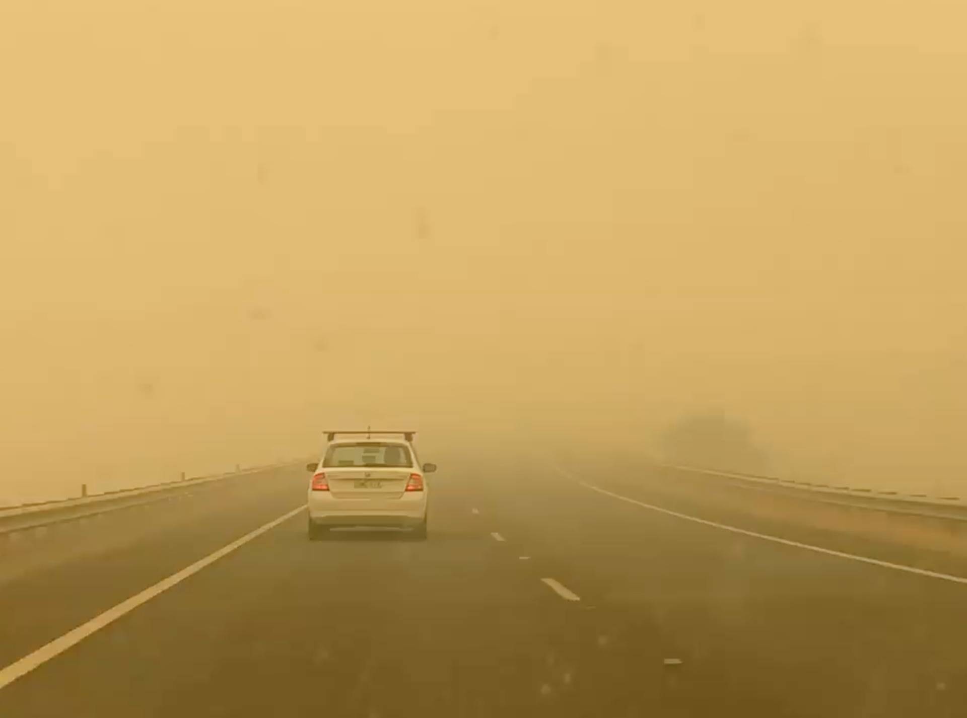 Car drives in smog on the road to Cooma from Canberra in Bredbo