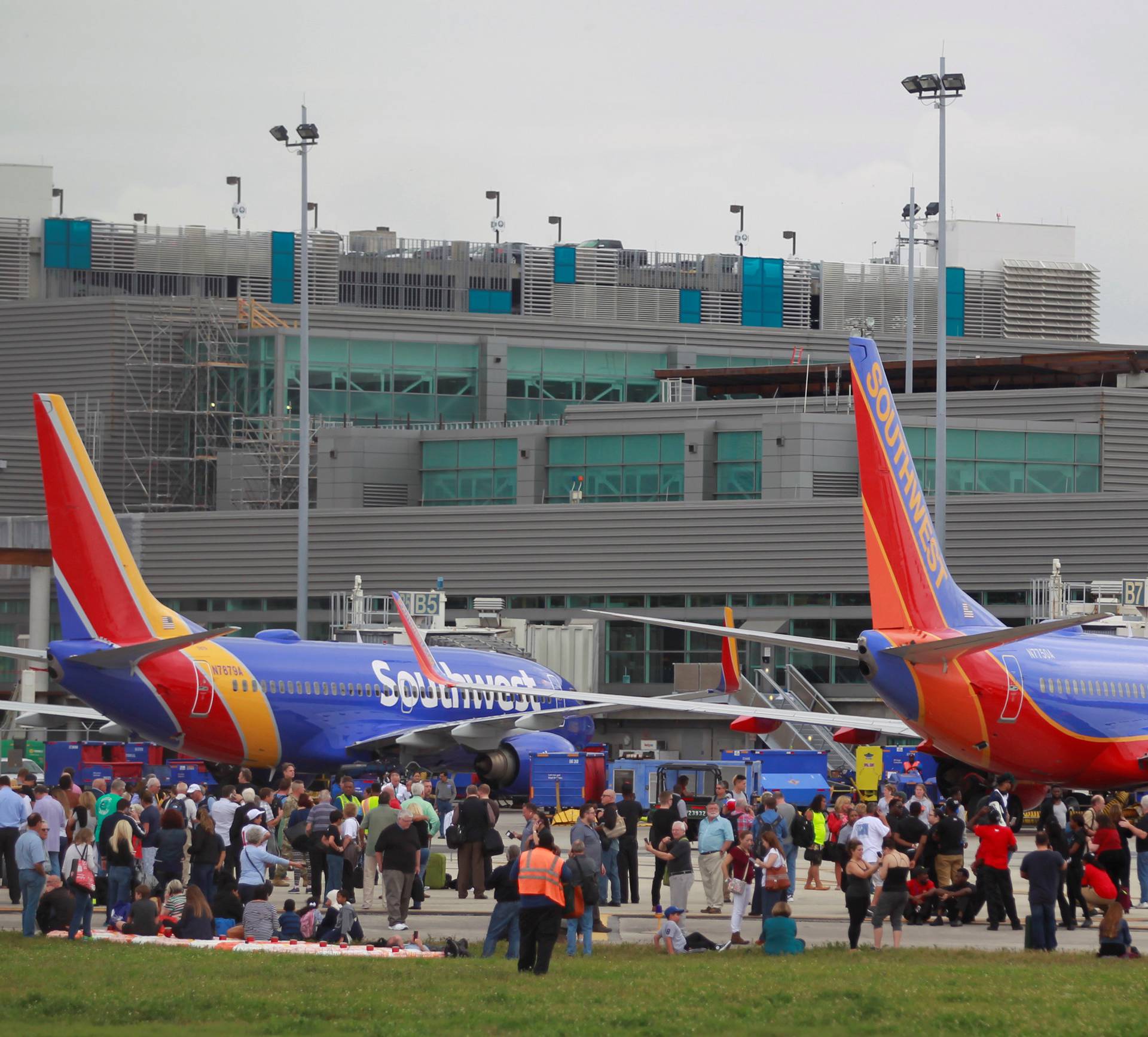 People on the airport ramp area near terminals 1 and 2 are seen following a shooting incident at Fort Lauderdale-Hollywood International Airport in Fort Lauderdale, Florida