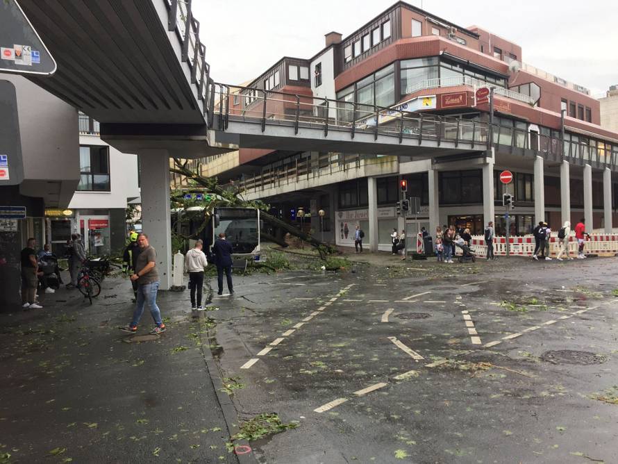 People walk on the streets in the aftermath of a tornado that swept through the town of Paderborn
