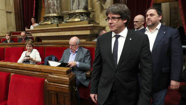 Catalan President Carles Puigdemont arrives in the chamber at the Catalonian regional parliament in Barcelona