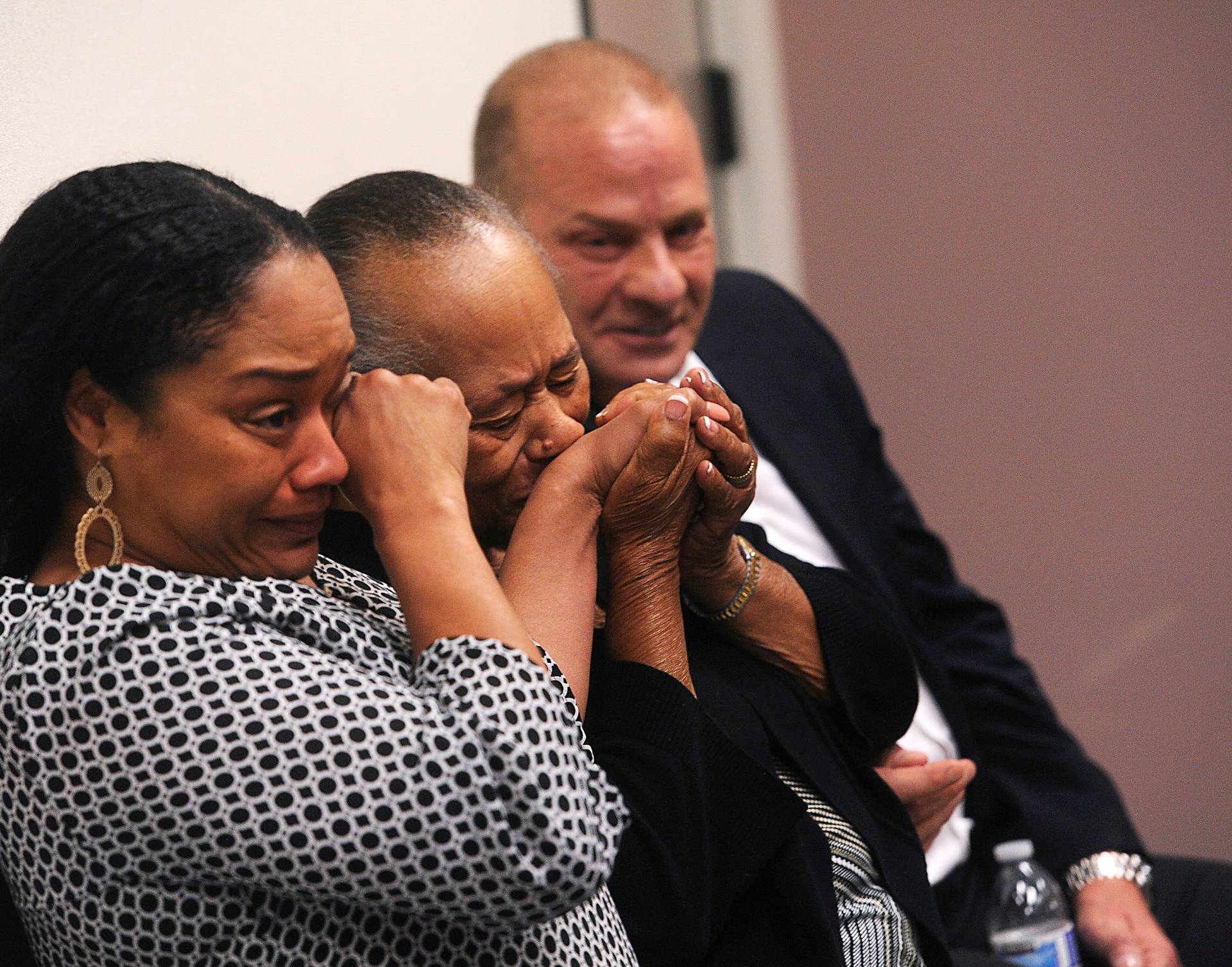 O.J. Simpson's sister Shirley Baker, (center), daughter Arielle Simpson, (L), and friend Tom Scotto react during Simpson's parole hearing at Lovelock Correctional Centre in Lovelock