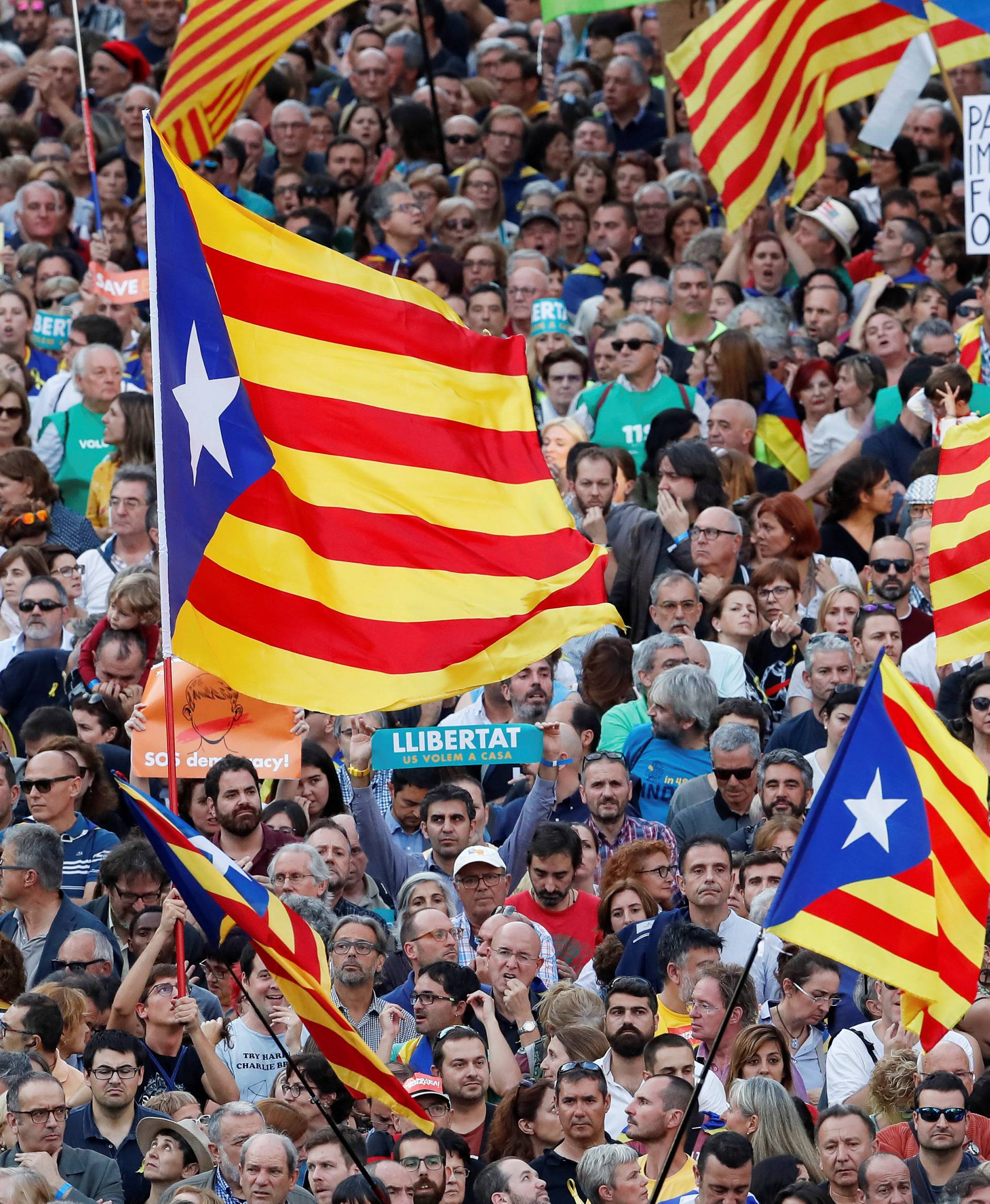 People wave Catalan separatist flags during a demonstration organised by Catalan pro-independence movements ANC (Catalan National Assembly) and Omnium Cutural, following the imprisonment of their two leaders Jordi Sanchez and Jordi Cuixart, in Barcelona