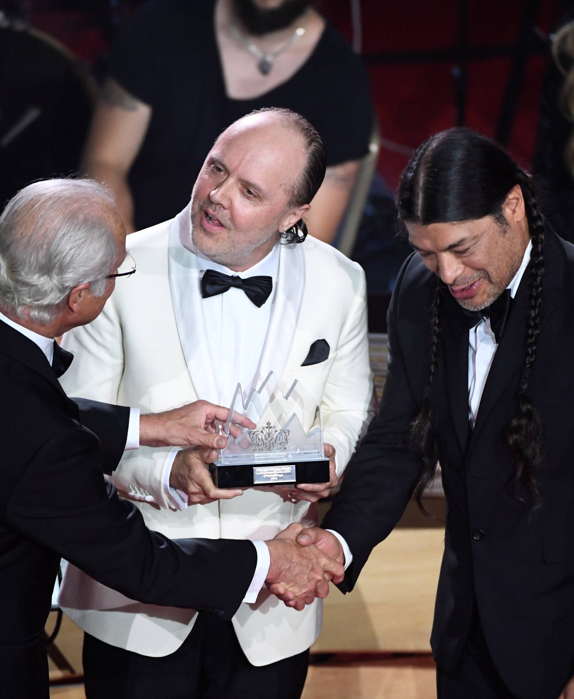 King Carl Gustaf of Sweden gives out the Polar Music Prize to Lars Ulric and Robert Trujillo in Metallica during an award cermony at Grand Hotel in Stockholm