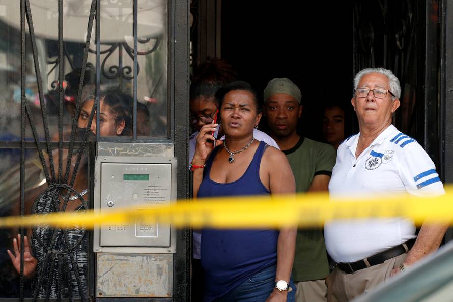 People watch near the scene at Bronx-Lebanon Hospital, after an incident in which a gunman fired shots inside the hospital in New York