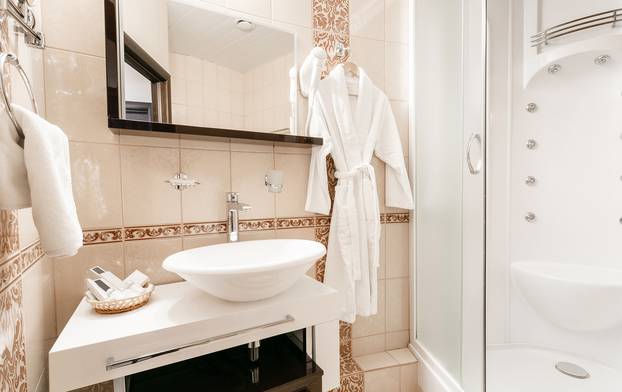 Bathroom Inside rooms of a apartment or hotel. Clean white towel