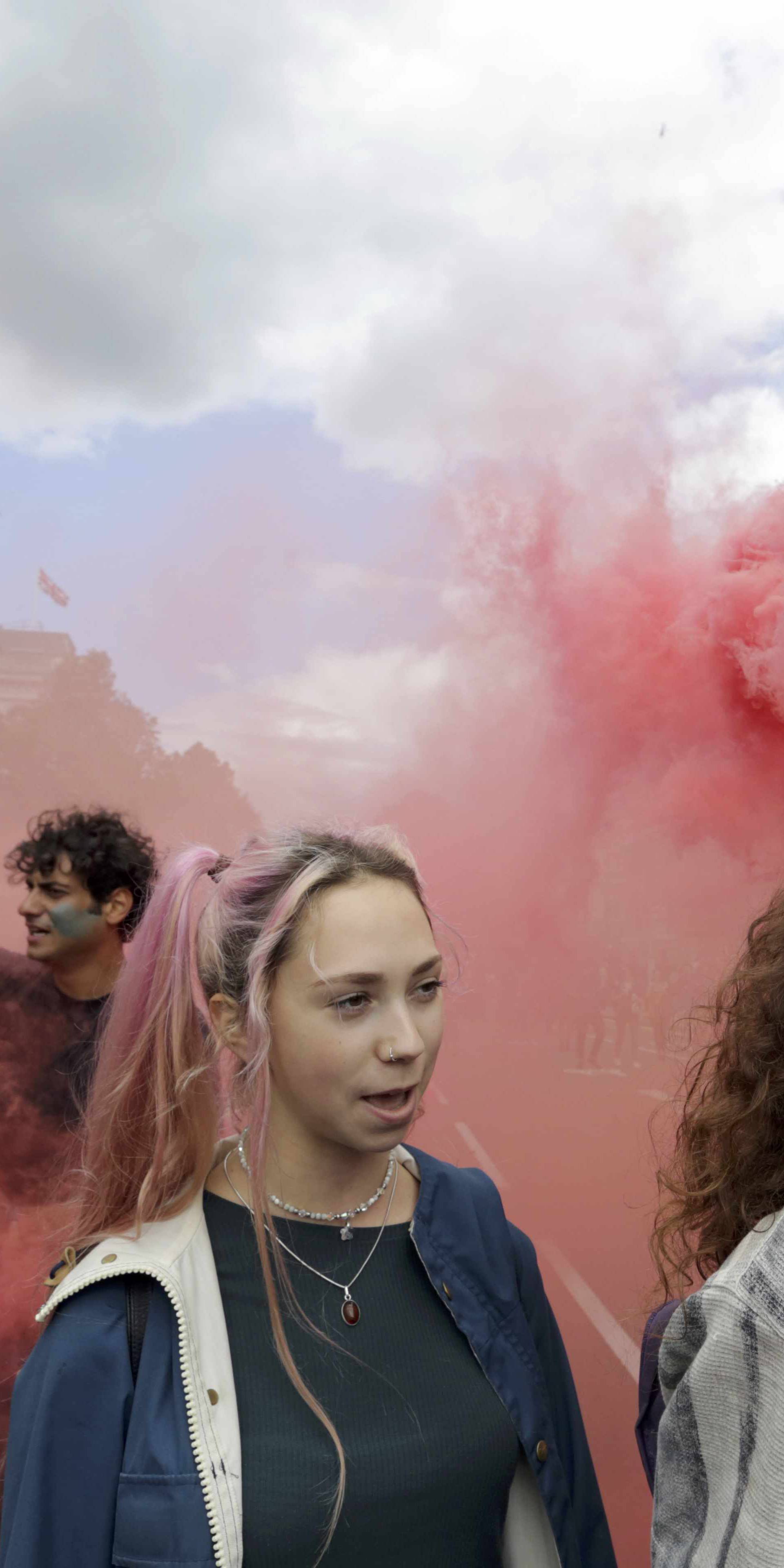 A womand holds a flare during a 'March for Europe' demonstration against Britain's decision to leave the European Union, in Parliament Square, central London
