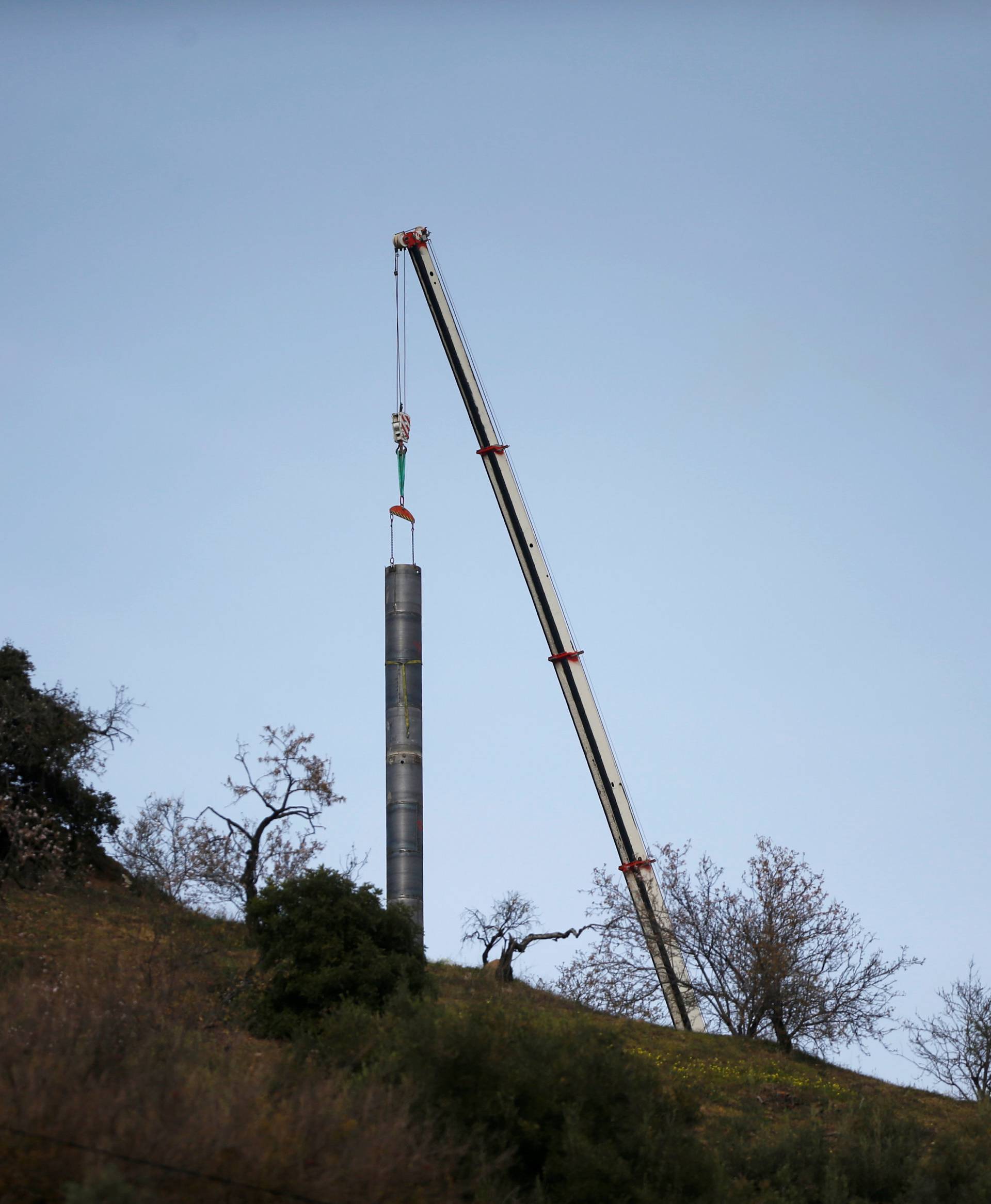 A crane removes steel tubes after failing to place them into the drilled well at the area where Julen, a Spanish two-year-old boy, fell into a deep well nine days ago when the family was taking a stroll through a private estate, in Totalan