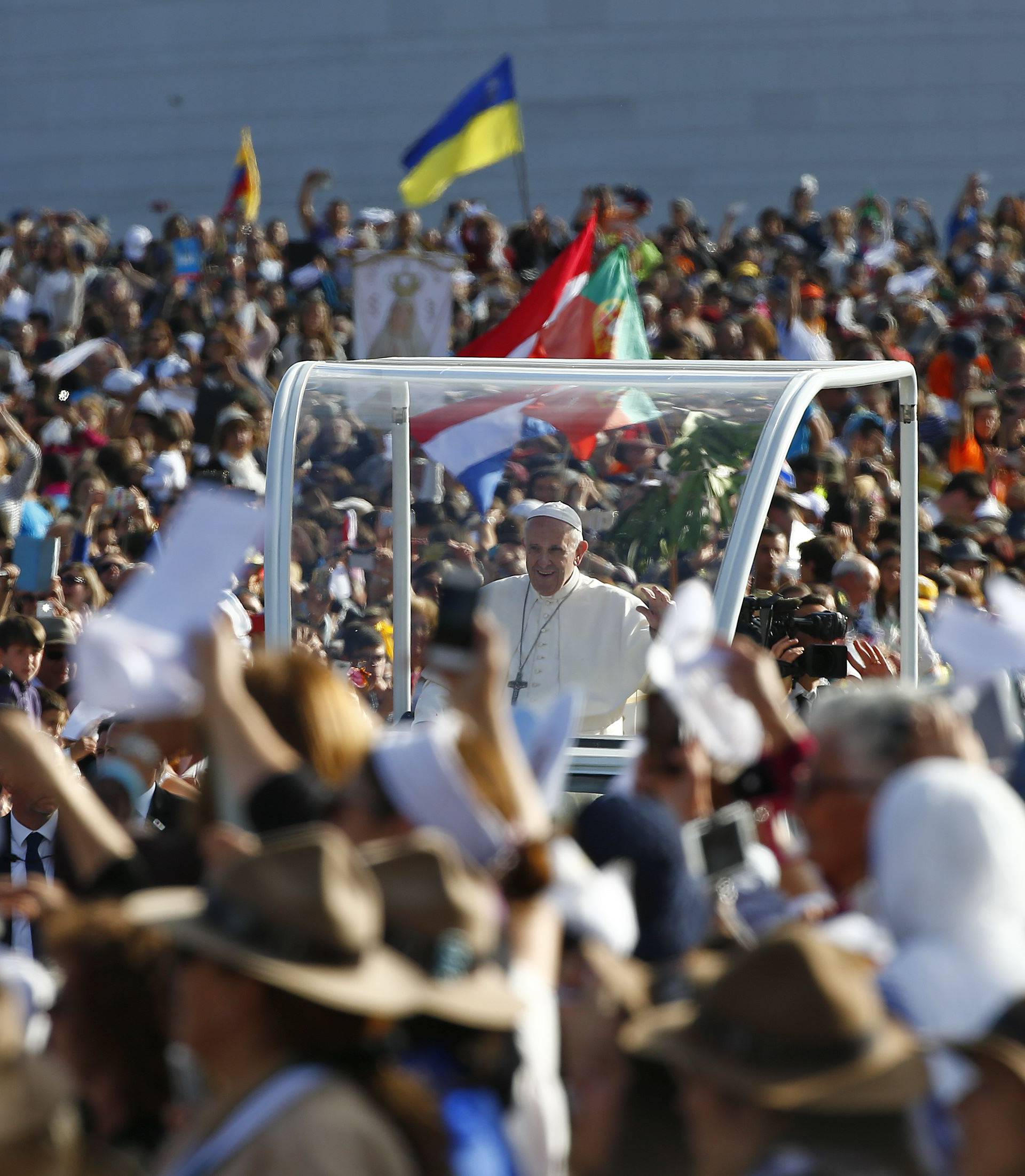 Pope Francis waves as he arrives at the Shrine of Our Lady of Fatima in Portugal