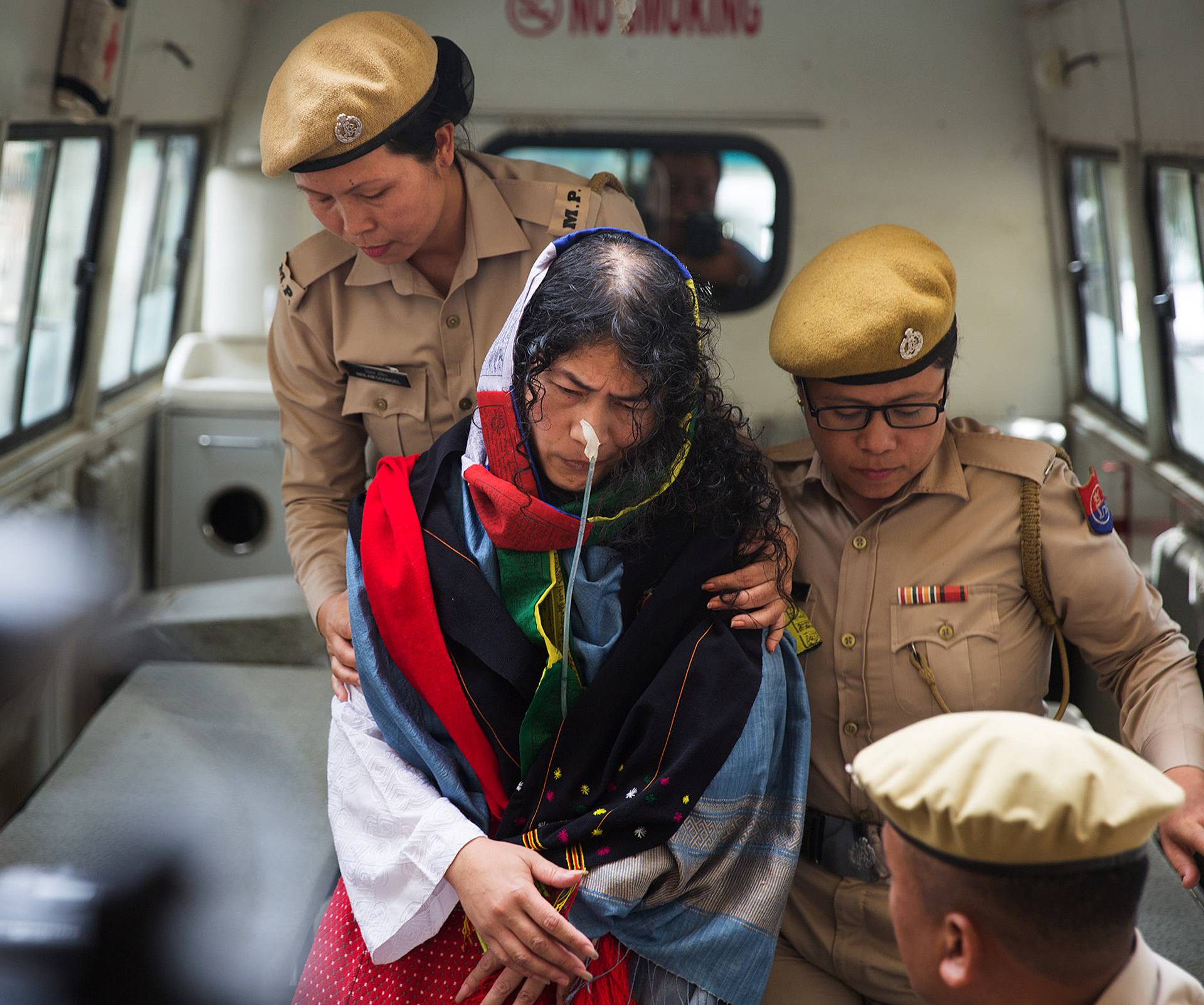 Policewomen escort Indian human rights activist Irom Sharmila as she arrives at a court in the northeastern city of Imphal